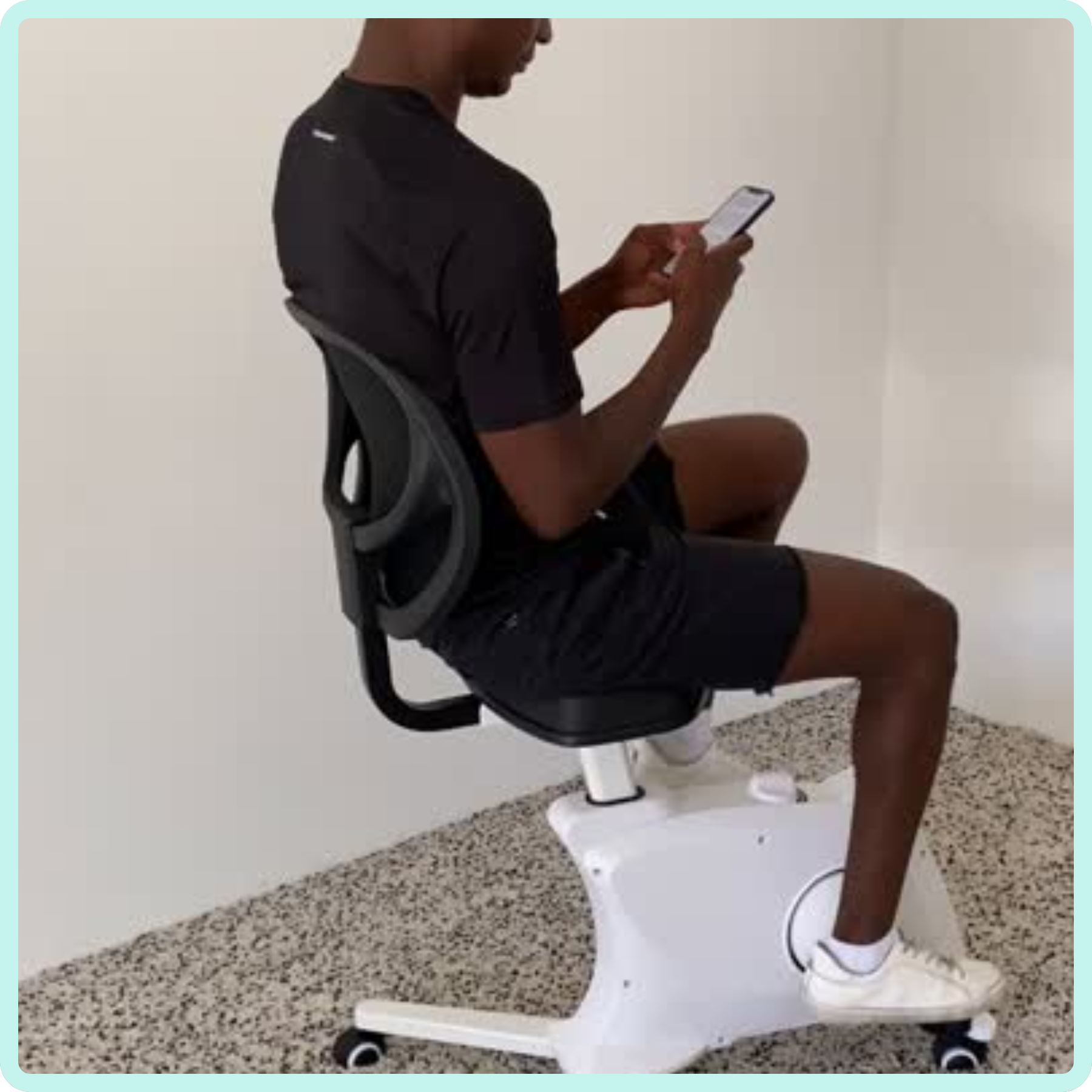 video of man peddling on bikedesk og whilst on phone